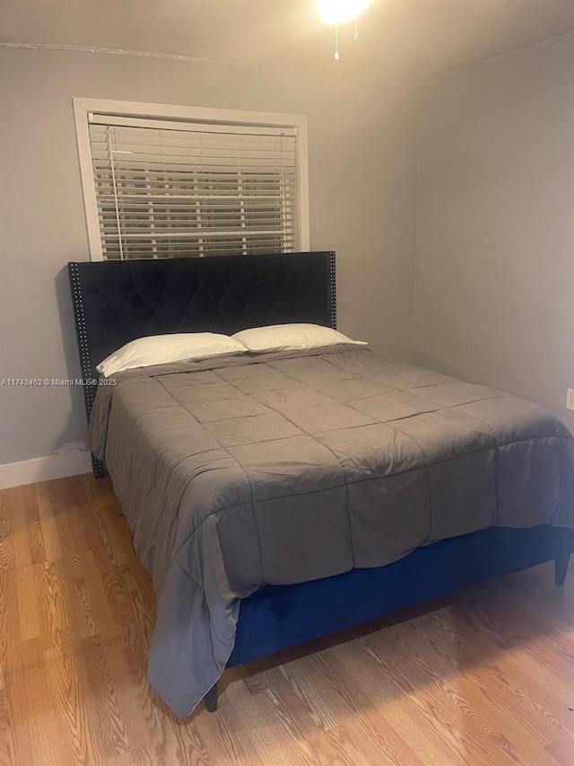 bedroom with wood-type flooring