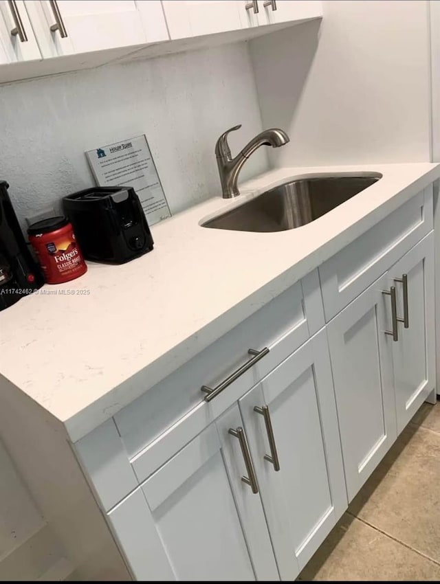 room details with white cabinetry and sink