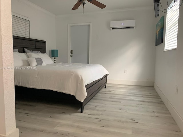 bedroom featuring crown molding, a wall mounted AC, ceiling fan, and light wood-type flooring