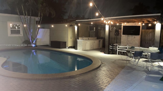 view of swimming pool featuring a patio and area for grilling