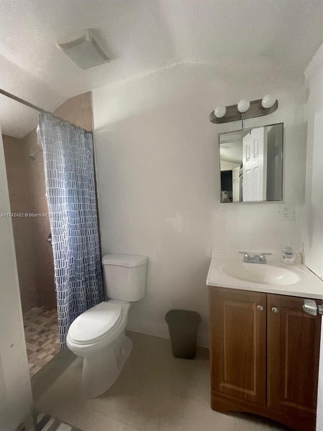 bathroom with walk in shower, vanity, toilet, and a textured ceiling