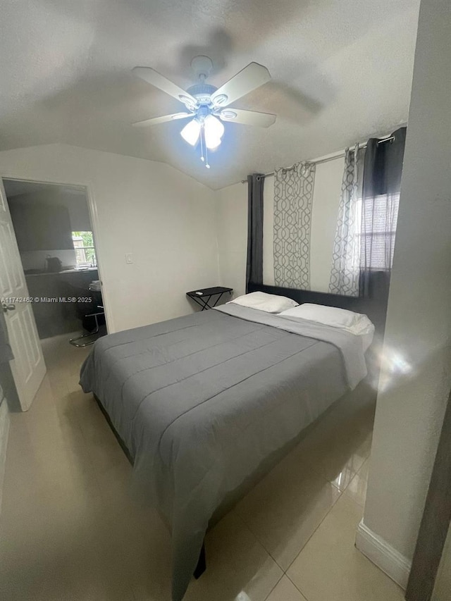 tiled bedroom with ceiling fan