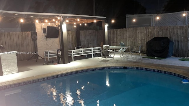 view of swimming pool with a grill and a patio area