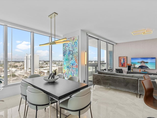 dining space featuring plenty of natural light and floor to ceiling windows