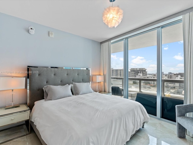 bedroom with a city view and a wall of windows