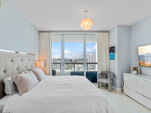 bedroom featuring a city view, expansive windows, and baseboards