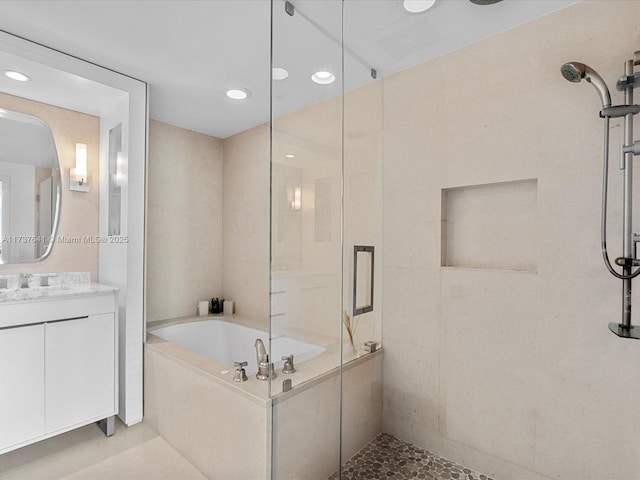 full bathroom with vanity, recessed lighting, a stall shower, and a garden tub