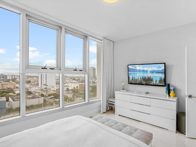 bedroom with a city view and light tile patterned flooring