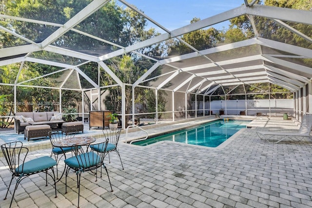 view of swimming pool featuring a fenced in pool, a lanai, fence, a patio area, and an outdoor living space