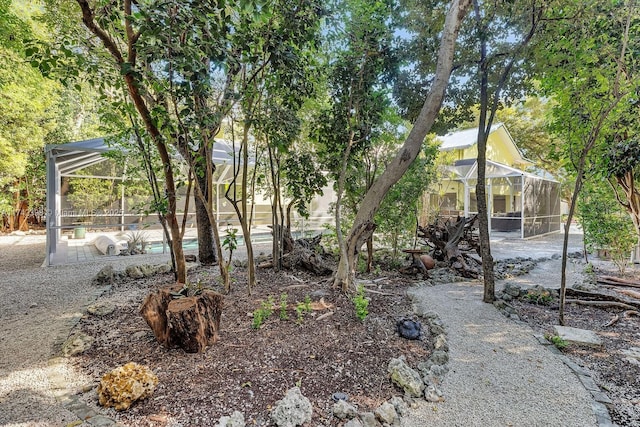 view of yard with a patio area, a lanai, and an outdoor pool