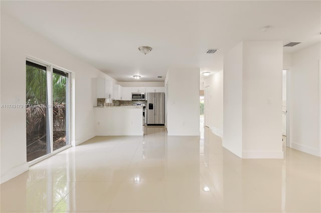 unfurnished living room featuring light tile patterned flooring