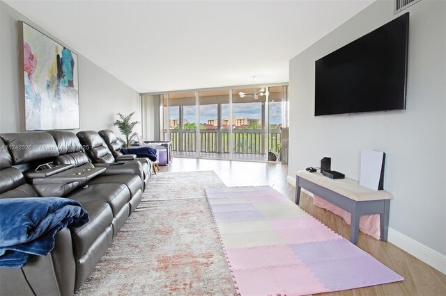 6911 Environ Blvd Unit 5L, Lauderhill, FL 33319 - living area featuring visible vents, baseboards, a chandelier, floor to ceiling windows, and wood finished floors