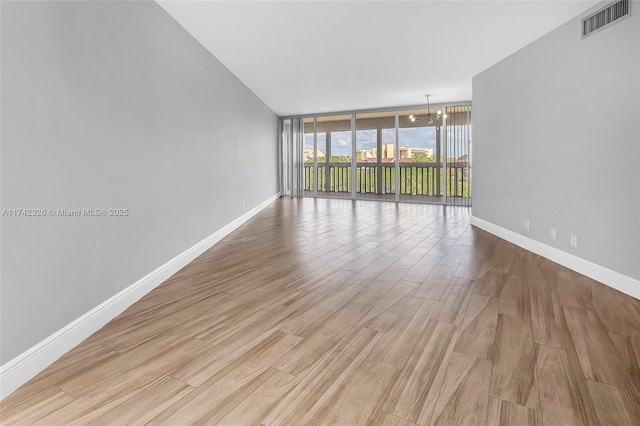 6911 Environ Blvd Unit 5L, Lauderhill, FL 33319 - unfurnished room featuring a wall of windows and light wood-style floors