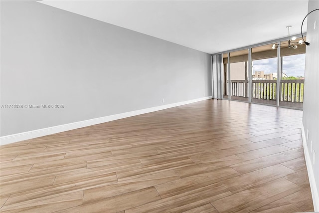6911 Environ Blvd Unit 5L, Lauderhill, FL 33319 - spare room featuring wood finished floors and a wall of windows