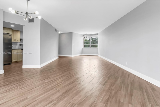 6911 Environ Blvd Unit 5L, Lauderhill, FL 33319 - unfurnished living room featuring a chandelier and light wood finished floors