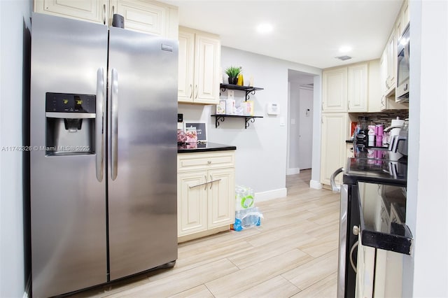 6911 Environ Blvd Unit 5L, Lauderhill, FL 33319 - kitchen featuring baseboards, open shelves, light wood-style flooring, stainless steel appliances, and dark countertops