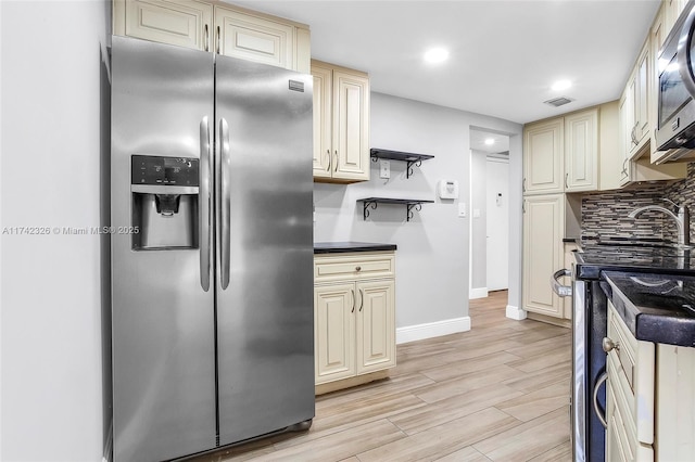 6911 Environ Blvd Unit 5L, Lauderhill, FL 33319 - kitchen featuring stainless steel appliances, cream cabinetry, light wood finished floors, tasteful backsplash, and recessed lighting