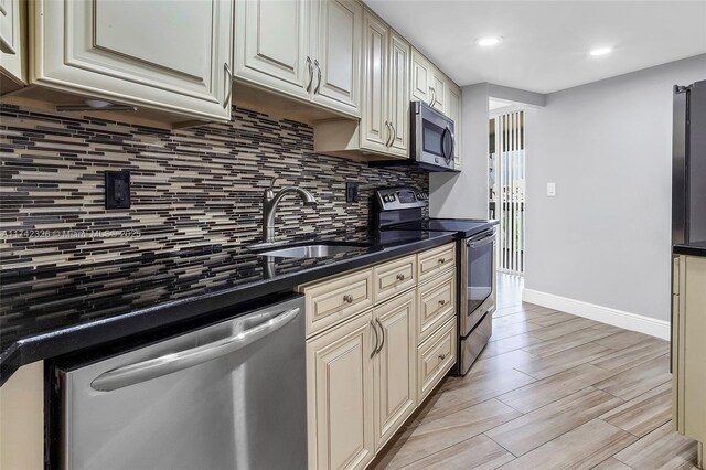 6911 Environ Blvd Unit 5L, Lauderhill, FL 33319 - kitchen featuring stainless steel appliances, backsplash, cream cabinets, and recessed lighting