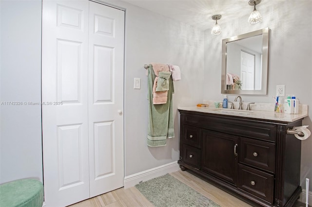 6911 Environ Blvd Unit 5L, Lauderhill, FL 33319 - bathroom featuring a closet, baseboards, wood finished floors, and vanity