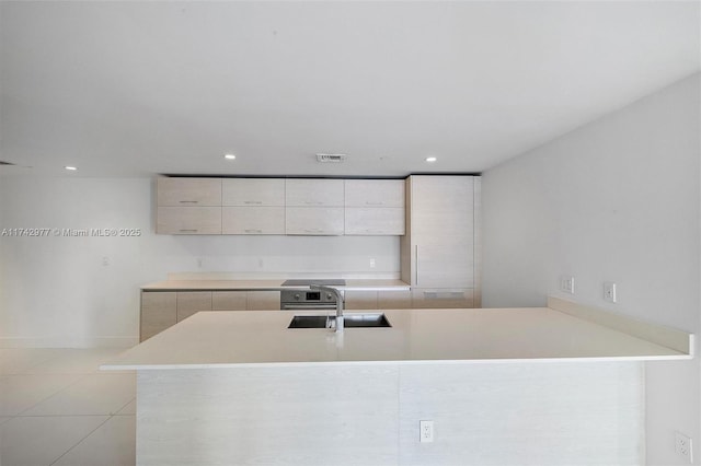 kitchen with light tile patterned flooring and sink