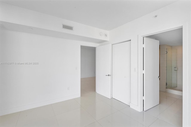 unfurnished bedroom with light tile patterned flooring and a closet