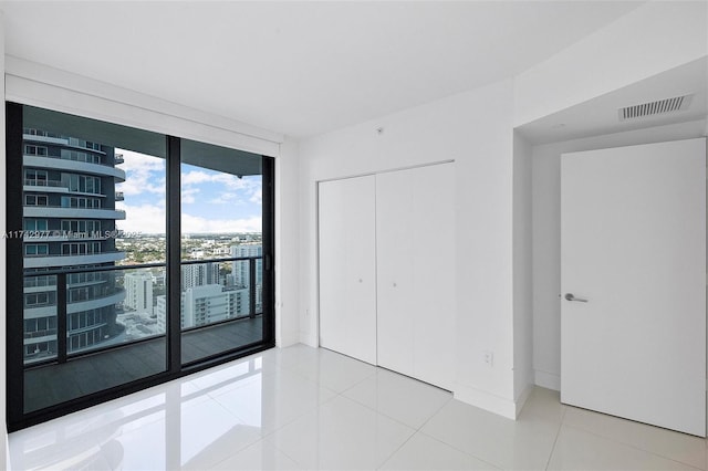 tiled empty room with expansive windows