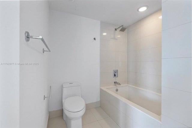 bathroom featuring toilet, tiled shower / bath combo, and tile patterned flooring