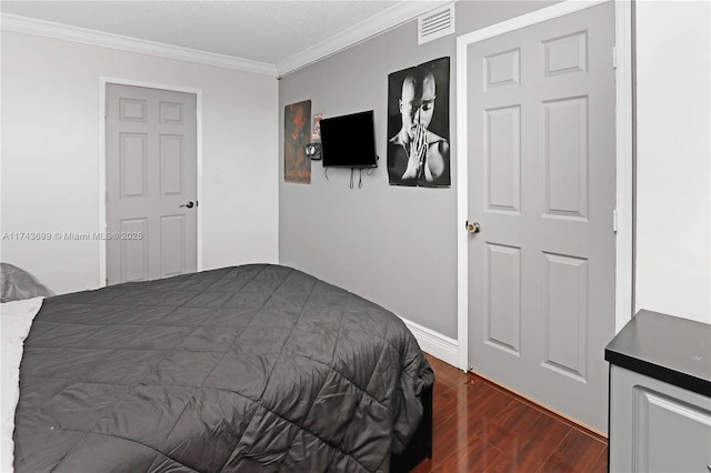 bedroom with crown molding and dark wood-type flooring