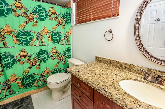 bathroom featuring vanity, tile patterned floors, and toilet