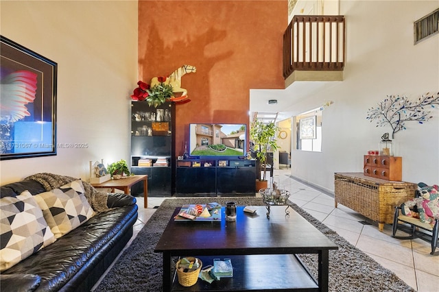 tiled living room with a towering ceiling