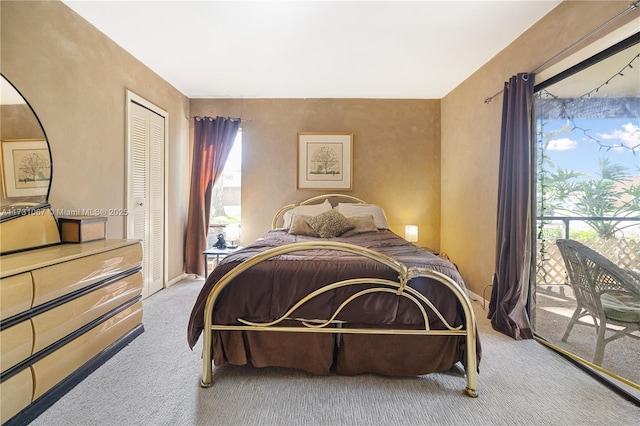 carpeted bedroom featuring access to outside and a closet