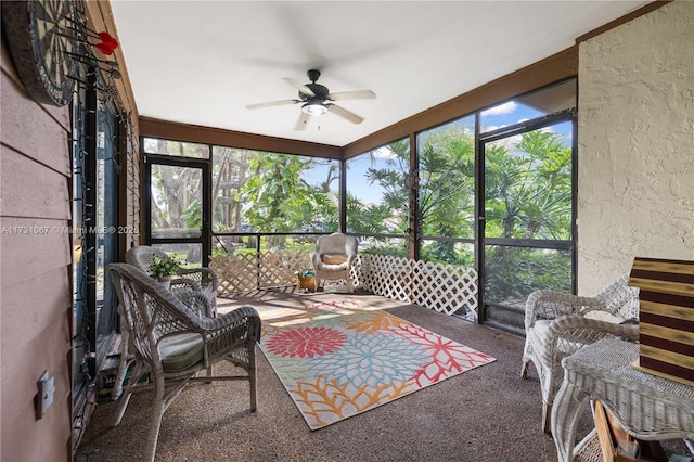 sunroom / solarium featuring ceiling fan