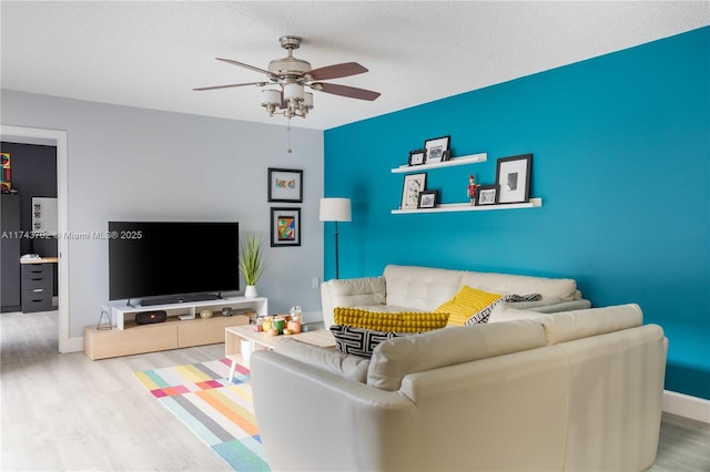 living room featuring light hardwood / wood-style floors and ceiling fan