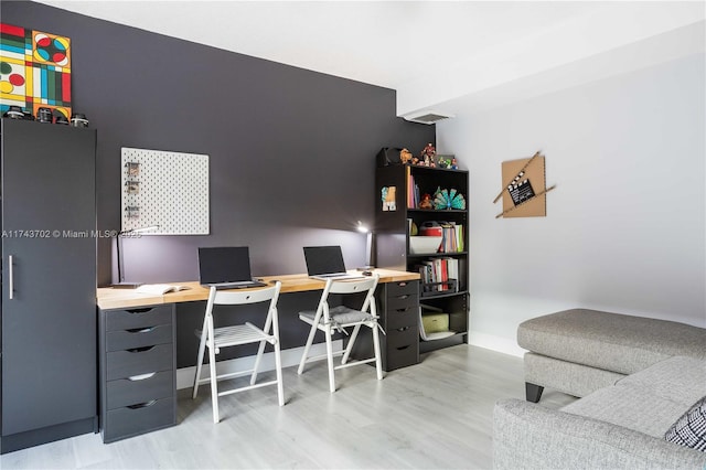 office space with light hardwood / wood-style flooring