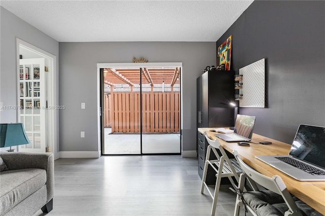 office area with light hardwood / wood-style flooring