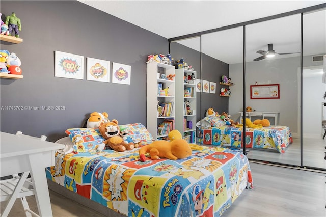 bedroom featuring light hardwood / wood-style floors and a closet