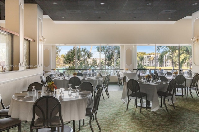 dining space with a towering ceiling and ornamental molding