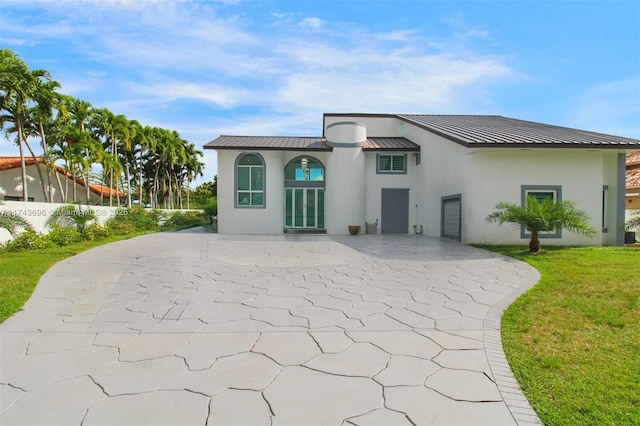 rear view of property featuring a lawn