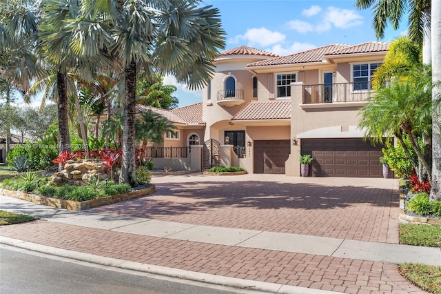 mediterranean / spanish home with a balcony and a garage