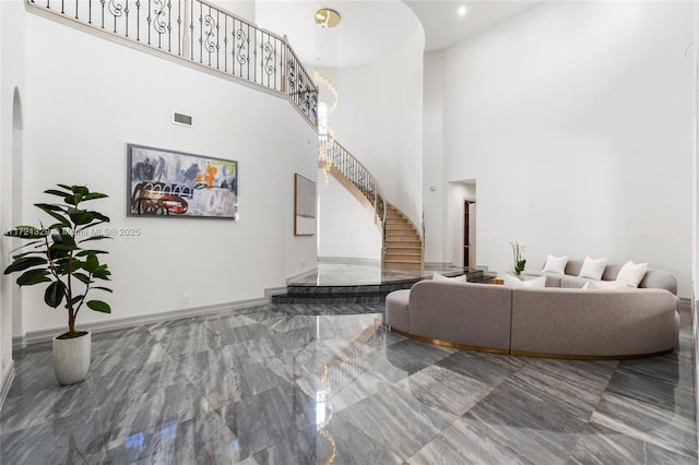 living room with a towering ceiling