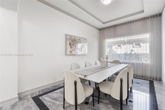 dining area with a raised ceiling