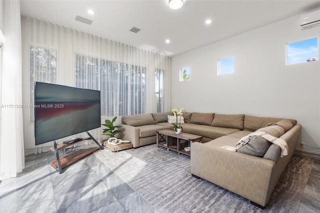 living room with plenty of natural light and a wall unit AC