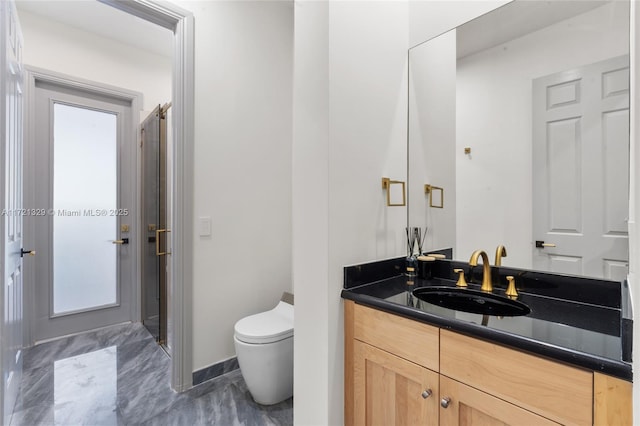 bathroom with vanity and toilet