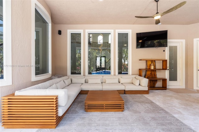 unfurnished living room with ceiling fan