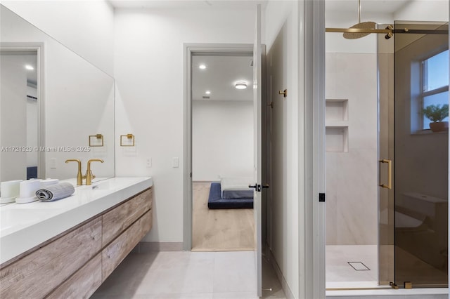 bathroom featuring tile patterned floors, vanity, and a shower with door