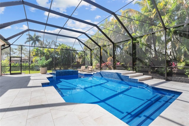 view of swimming pool with a lanai, a patio, and an in ground hot tub