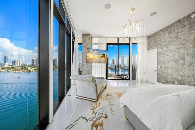 bedroom with a view of city, a chandelier, access to exterior, and floor to ceiling windows