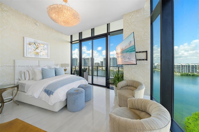 bedroom featuring access to outside, a city view, wallpapered walls, and a wall of windows