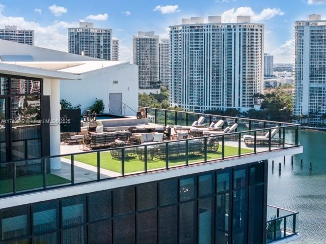 view of pool featuring a water view and a view of city