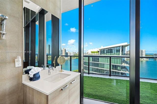 bathroom featuring a city view, vanity, and a water view